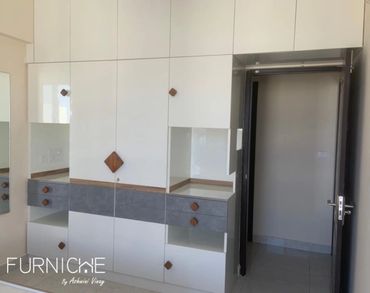 Wardrobes-Bright finish and ample storage with customized teak wood handles 