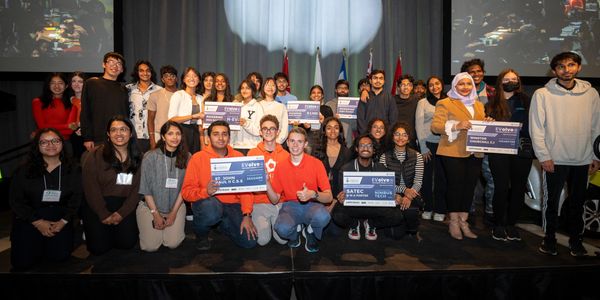 Multiple teams of students smiling who won Hackathon awards.