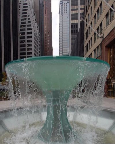 Water fountain flowing in an urban cityscape.