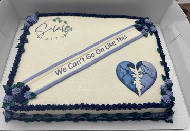 A decorated cake with a broken heart and the phrase 'We Can't Go On Like This'.