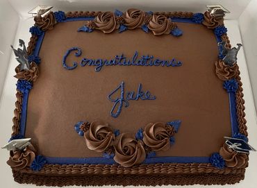 Chocolate graduation cake with blue decorations and "Congratulations Jake".