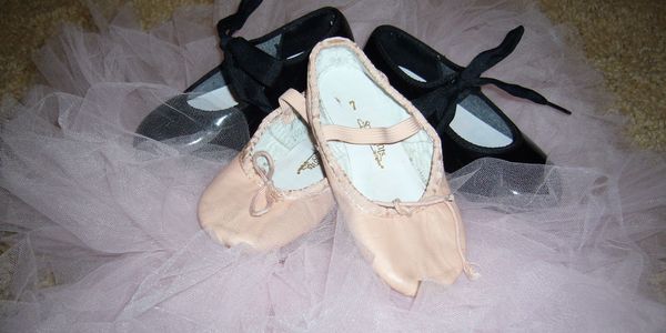 Children's Ballet and Tap Shoes Sitting on Tutu