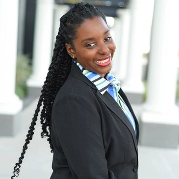 Woman in black coat smiling and looking forward