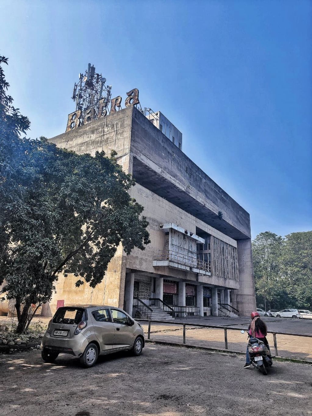 Old concrete building with 'Baba' sign on top.
