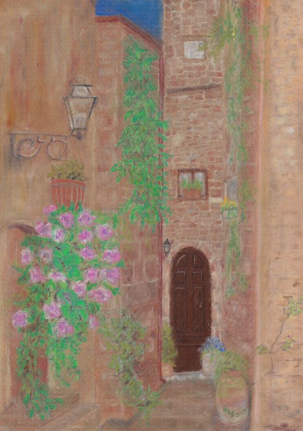Charming narrow alley with stone walls, flowering plants, and a wooden door.