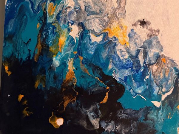 Abstract fluid art with swirling blues, blacks, and golds.