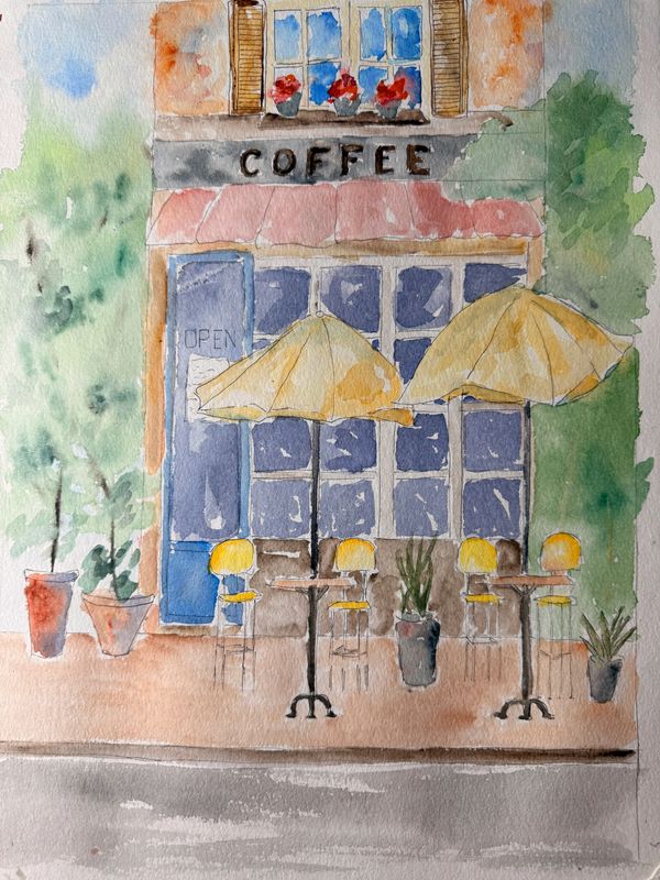 Watercolor painting of a quaint coffee shop with outdoor seating and yellow umbrellas.