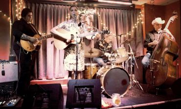 A four-piece band performing live in a cozy venue.