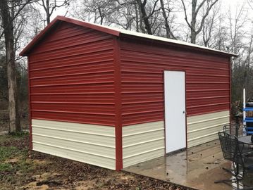 Red and beige metal shed in a backyard.