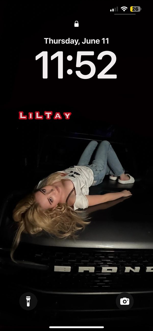 LiLTay on a truck hood tee and jeans lock screen wallpaper