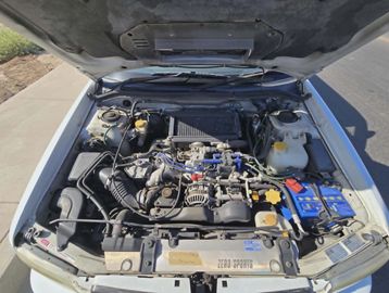 Open hood showing a clean car engine with labeled components.