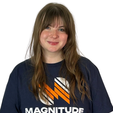 Smiling woman wearing a navy blue Magnitude t-shirt.