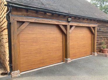 2x custom size Golden oak hormann sectional doors with natural oak surround