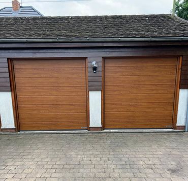 2x hormann sectional doors in golden oak with matching surround