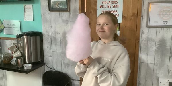 child holding candy floss at white wolf activity centre