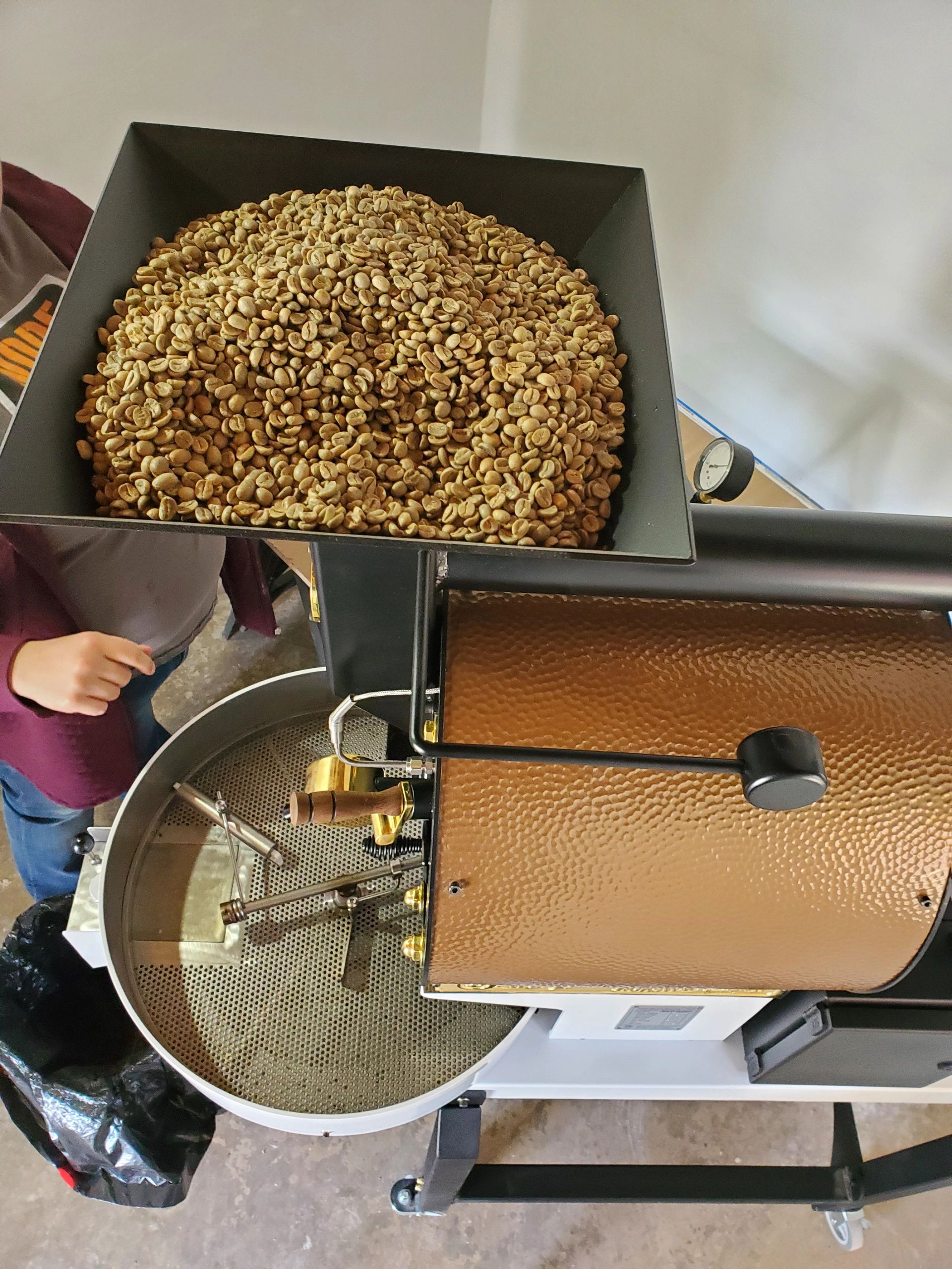 Seasoning the machine with old beans- the beans became Christmas ornaments and coasters...