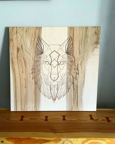 Geometric wolf engraving on wood