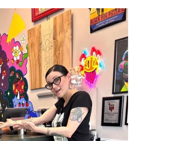 Woman standing in front of a wall of art