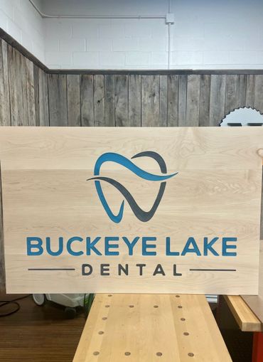 A wooden sign with buckeye lake dental on it