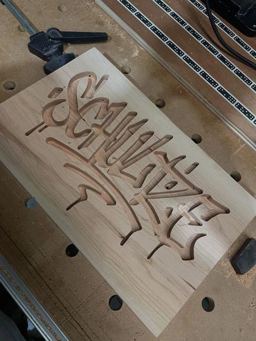 Finished engraved graffiti tag on a piece of wood