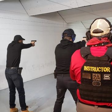 A group of people shooting in a shooting range.