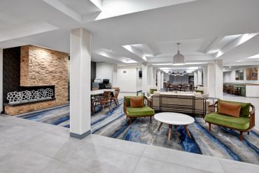 Modern lounge area with stylish seating and fireplace.