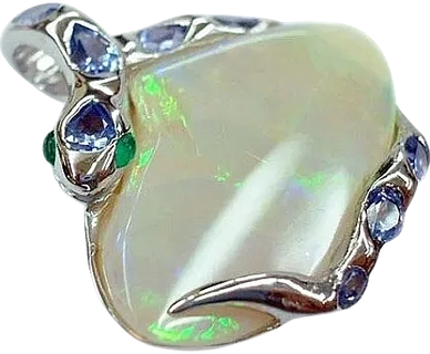18kt White Gold Snake Pendant
set with Emerald Eyes, Tanzanite Scales & an Opalized Clam shell
