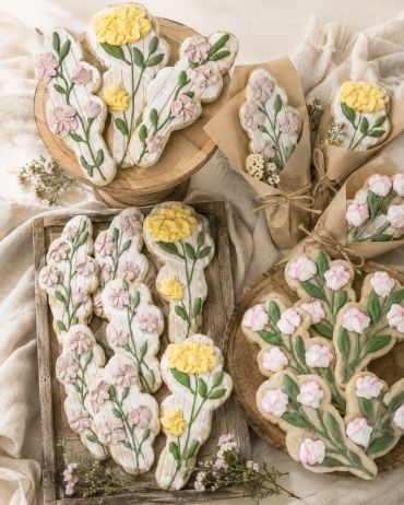Butterfly-shaped cookies decorated with floral icing.