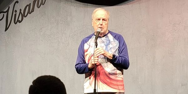A man giving speech on the stage