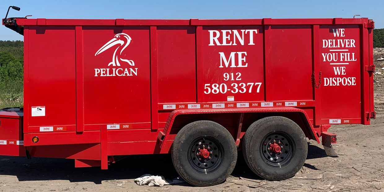 Bright red Pelican rental dumpster with contact info and service details.