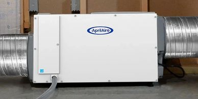 AprilAire indoor air quality system with duct connections.