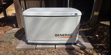 Generac 14kW standby generator installed outdoors on a concrete pad.