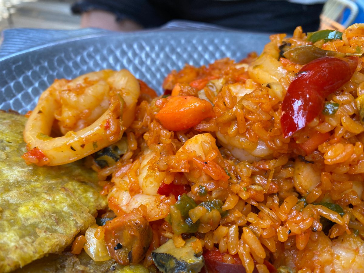 Close-up of spicy seafood rice with shrimp and plantains.