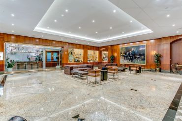 Spacious hotel lobby with modern seating and artwork.