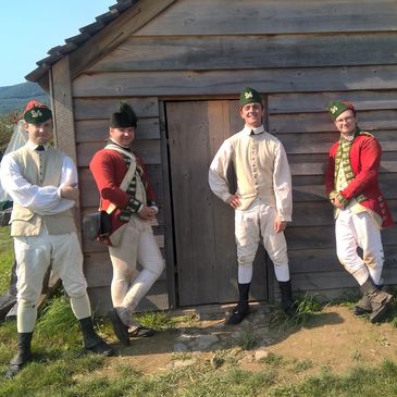 Reenacter Soldiers of His Majesty's 24th Regiment of Foot in front of their cabin at Fort Ticonderoga.