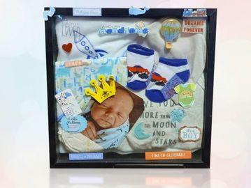 Framed custom shadowbox keepsake featuring a newborn baby photo, with themed decorations and text.