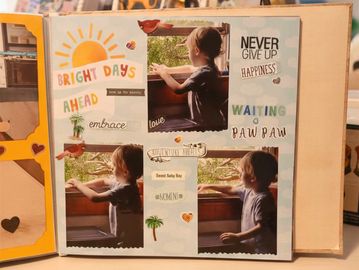 Scrapbook page with photos of a child by the window and uplifting phrases.