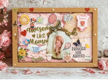 Decorative baby announcement framed keepsake shadowbox customized with floral and heart accents.