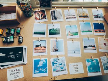A table with film rolls, printed photos, and prints.
