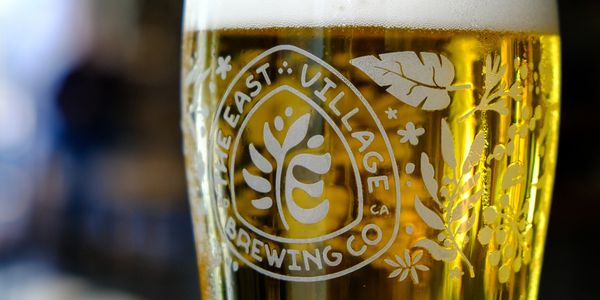 A close-up of a beer glass from East Village Brewing Co.