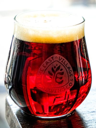 Glass of amber beer with foam on top.