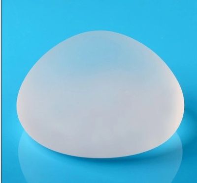 textured allergan breast implant sitting on blue counter