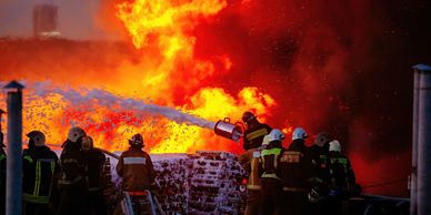 firefighter foam spraying on large fire