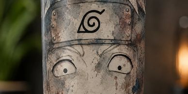 A weathered container with a cartoon face design.