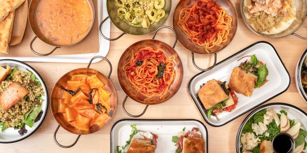 An assortment of Italian dishes including pasta and sandwiches.