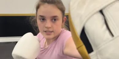 Young woman boxing with focus and determination.