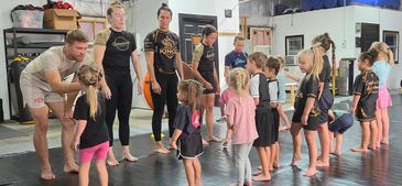 Children and adults in a martial arts class.