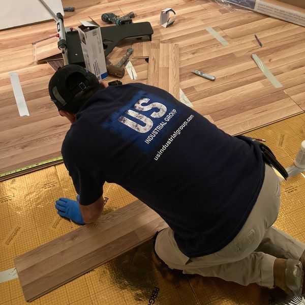 Man installing wood laminate floors.