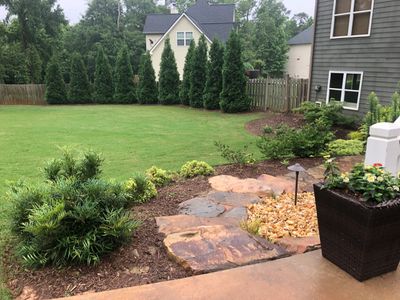 Fully landscaped and designed backyard in Hoschton, GA work done by Signature Lawn service