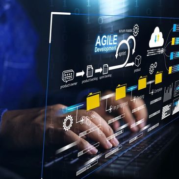 Hands typing on a keyboard with Agile development process graphics overlay.